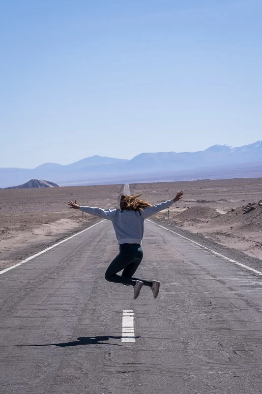 Jasmine jumping on the road in the Atacama desert